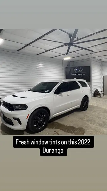 White SUV with fresh window tint at the shop